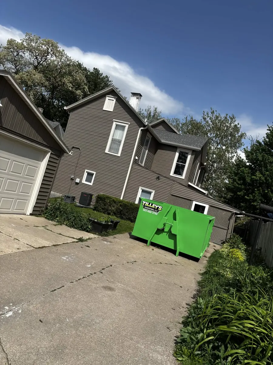 Tilley's green roll-off dumpster &mdash; Driveway job