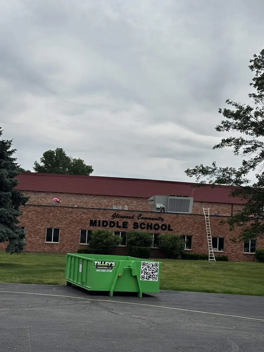 Tilley's green dumpster in front of Glenwood Community Middle School in Glenwood, Iowa